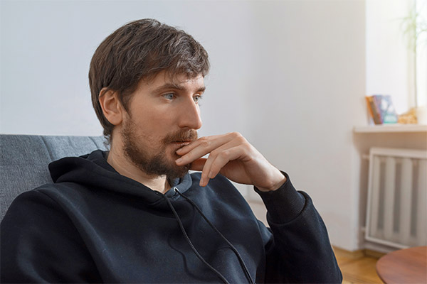 Young man looking away from camera in deep thought